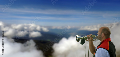 Horn player in the mountains photo