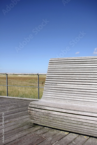 holzbank auf der seebrücke von sankt peter-ording photo