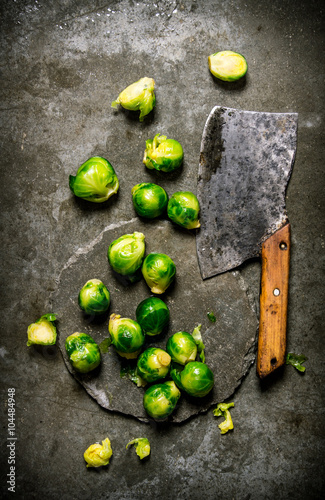 Brussels sprouts with a hatchet. On stone background. photo