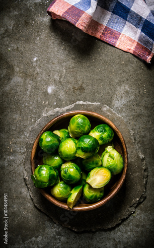 Brussels sprouts are in the Cup on stone table. © Artem Shadrin
