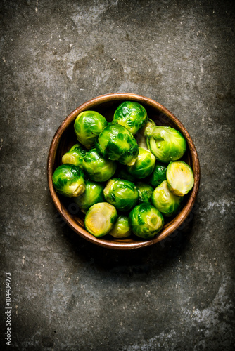 Brussels sprouts are in the Cup on stone table. © Artem Shadrin