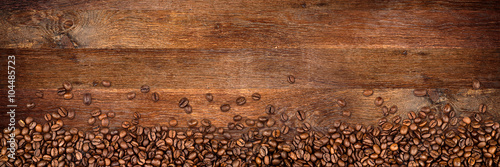 Valokuvatapetti coffee background with beans on rustic old oak wood