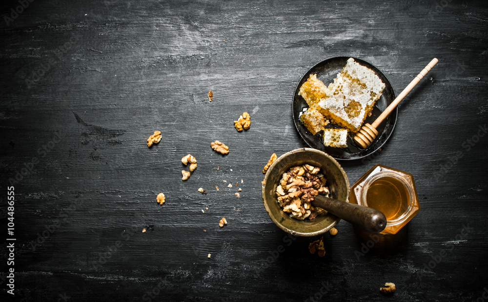 Walnuts in a mortar and sweet honey Walnuts in a mortar and sweet honey