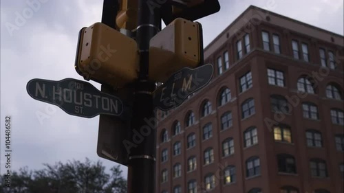 Cross street sign N. Houston St. and Elm St. with the Texas School Book Depository in the background. Dealey Plaza, Dallas, Texas. photo