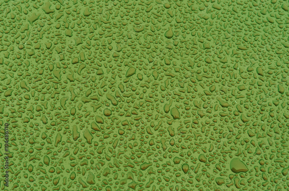 Green water drops on metal car surface. Green water drops on metal car surface.