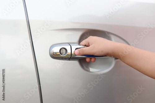 Hand boy pushing button of car handle to open car