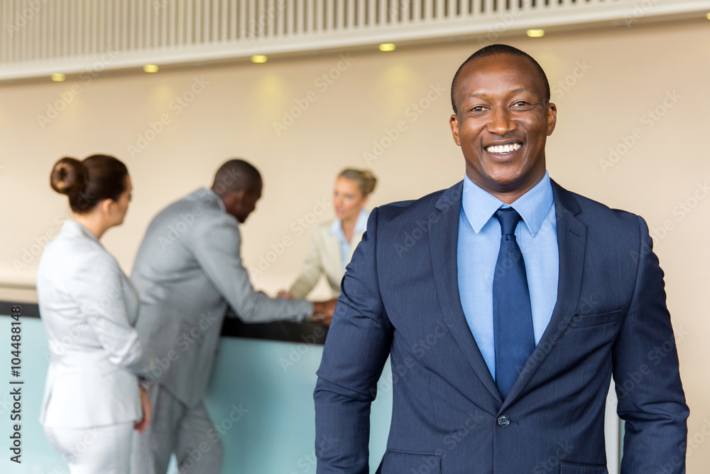 african businessman standing at hotel reception