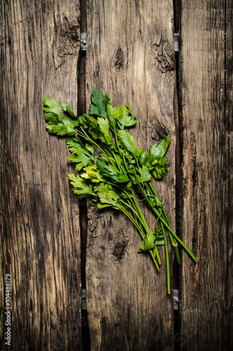 Fototapeta Naklejka Na Ścianę i Meble -  Green parsley. On wooden background.