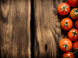 Fresh red tomatoes . On wooden background.