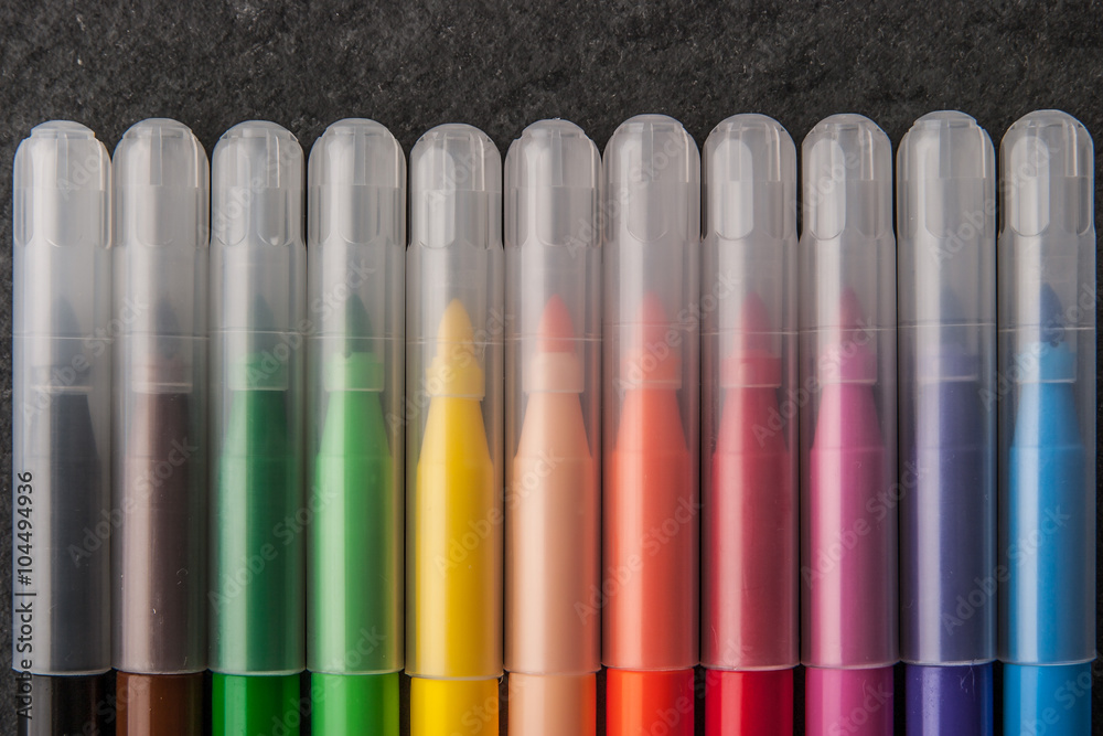 Fotografie Colorful felt pens on the dark stone background