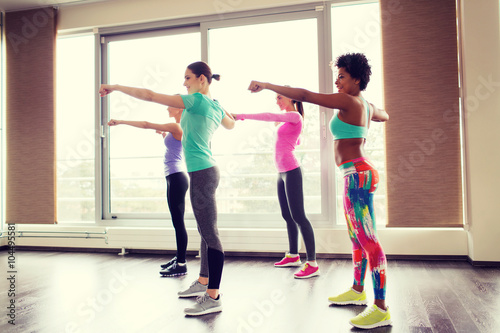 group of happy women working out in gym