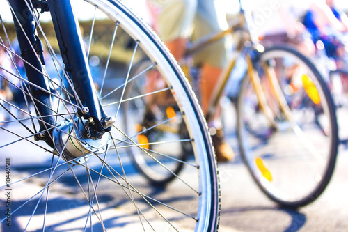 bicycle wheel detail with blurry cyclist