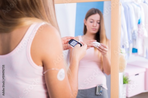 Woman holding glucometer