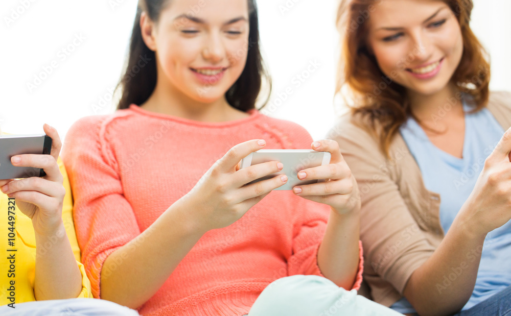 close up of women or friends with smartphones close up of women or friends with smartphones