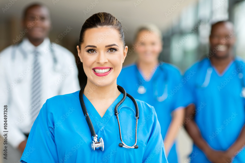 young female doctor standing with co-workers young female doctor standing with co-workers