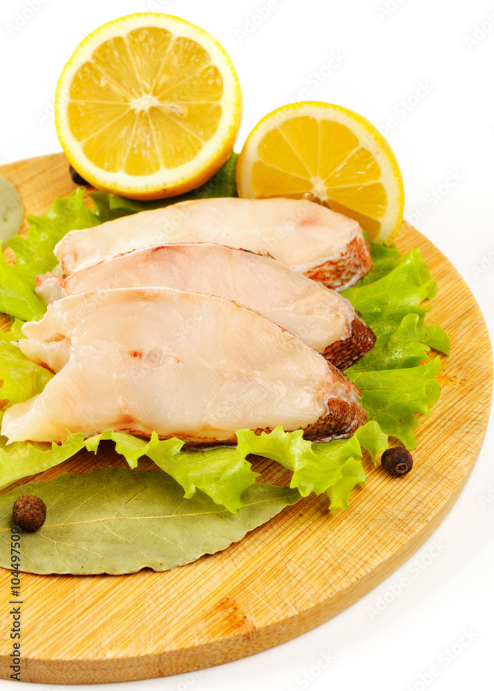 Pieces of sea bass on a cutting board. Pieces of sea bass on a cutting board.