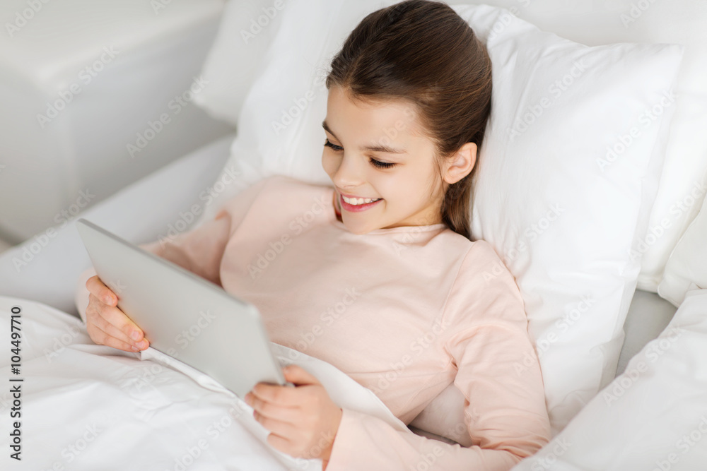 happy girl lying in bed with tablet pc at home happy girl lying in bed with tablet pc at home