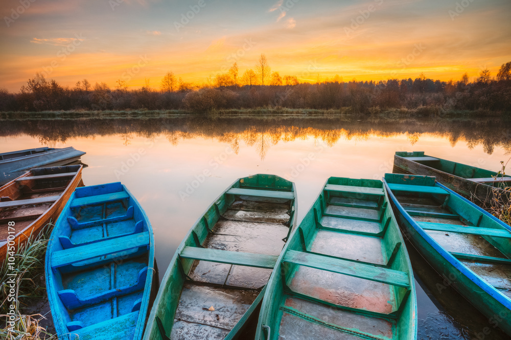 River and old rowing fishing boat at beautiful sunrise at mornin