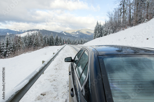 car on winter mountainins road photo