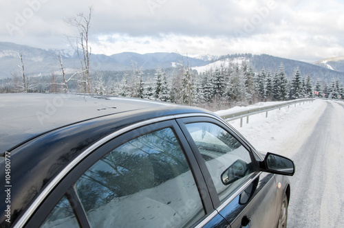 car on winter mountainins road photo