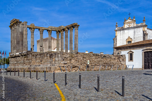 Evora, Portugal. The iconic Roman Temple dedicated to the Emperor cult, wrongly considered as a Goddess Diana Temple, with the Loios Convent used as a Historical Hotel. UNESCO World Heritage Site. photo