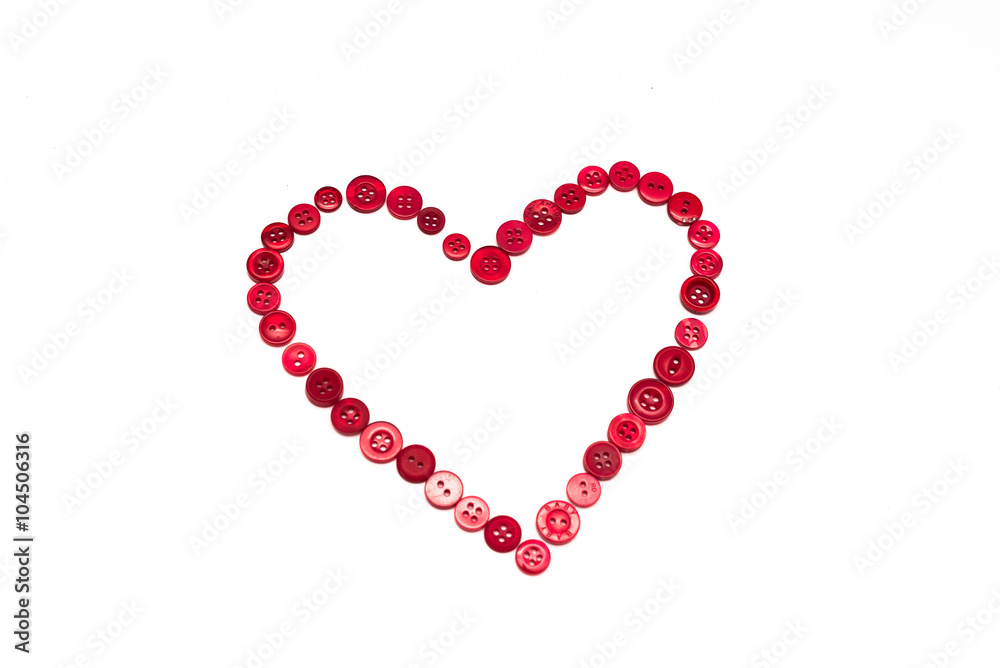 Heart shape made of red buttons