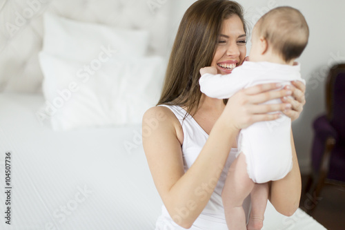 Happy mother with baby at home