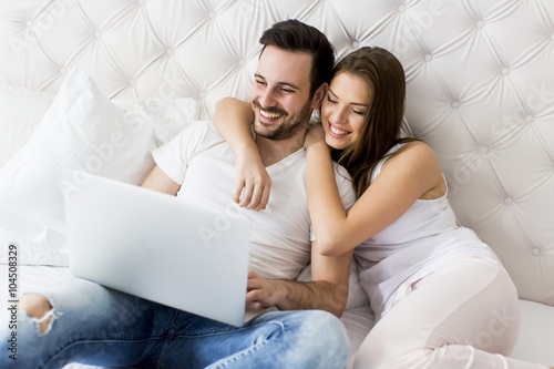 Young couple with laptop in...