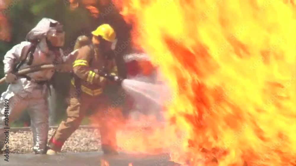 Firefights conduct a drill to simulate an airplane crash and fuel fire.