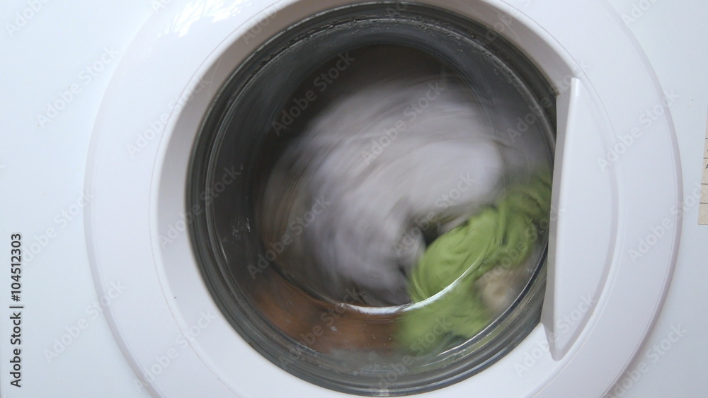 Washing machine washes clothes - front view