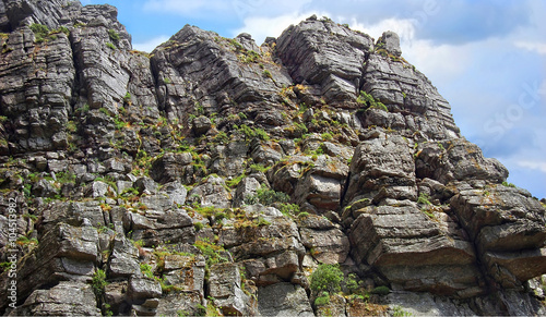 Steep Rocky Cliff./ Steep Rocky Cliff stretching into the sky.