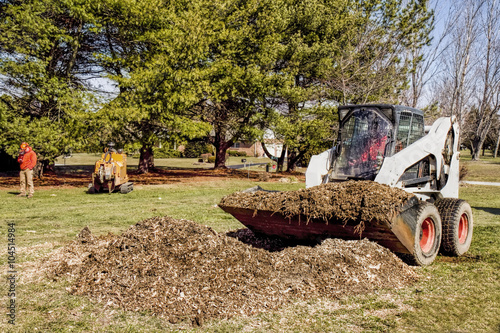 Dozer being used by landscapers to remove chips and debris after tree stump was grinded out.
