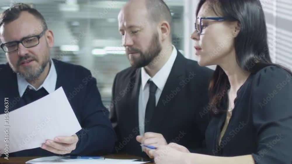 Team of employees are having a conversation in meeting room. Shot on RED Cinema Camera. Team of employees are having a conversation in meeting room. Shot on RED Cinema Camera.