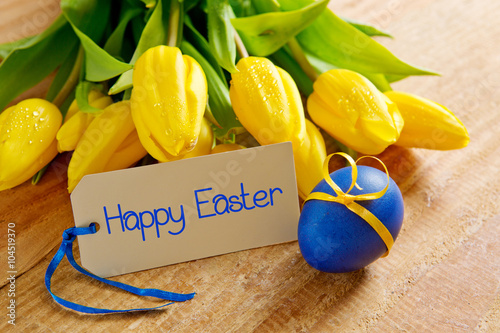  Yellow tulip bouquet  and easter egg isolated .