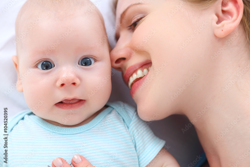 happy family mother kisses and hugs her baby happy family mother kisses and hugs her baby