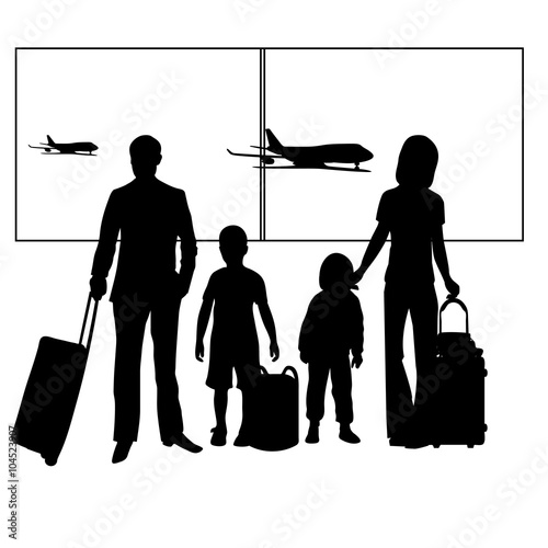 Family with two children and suitcases at the airport