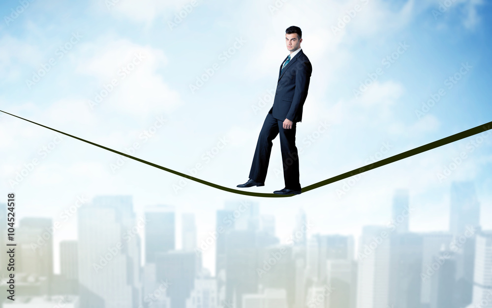 Salesman walking on rope above the city Salesman walking on rope above the city