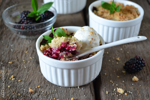 Bild auf Leinwand Blackberry crumble with oatmeal and almonds, rustic style