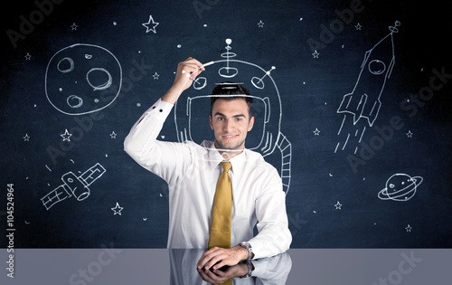 Sales person drawing helmet and space rocket