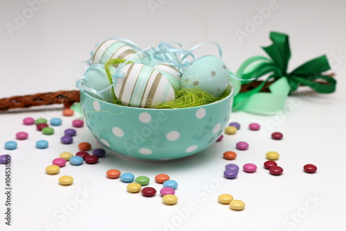 Decorated Easter eggs, colorful candies and a whip of willow twigs (Central Europe Easter symbol), isolated on white background