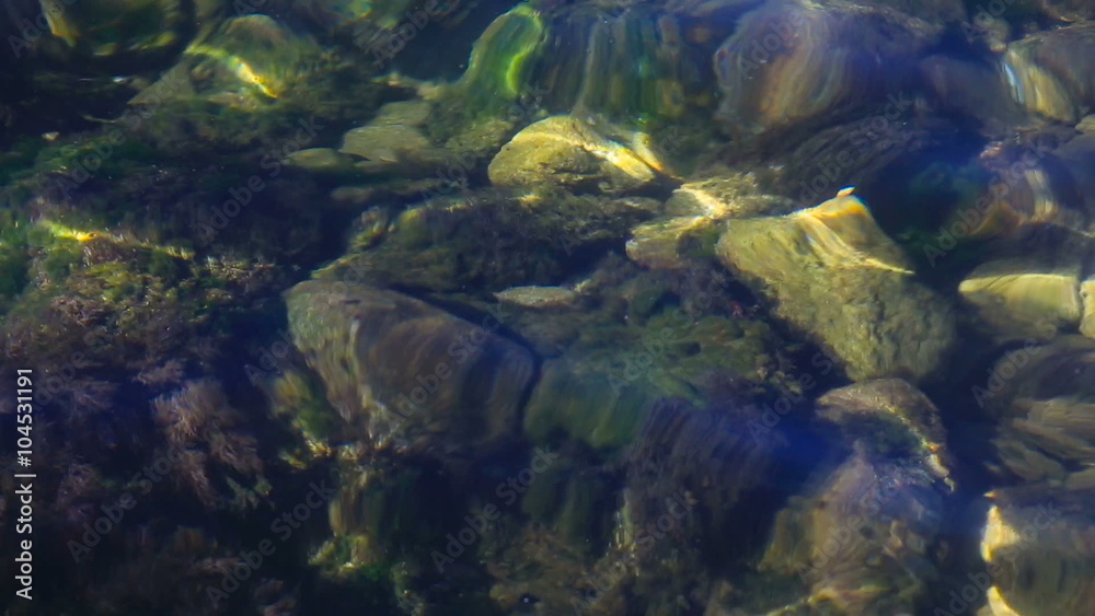 Water waves between stones on the sea beach. Water waves between stones on the sea beach.