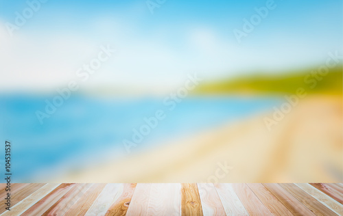 empty wooden deck table top Ready for product display montage with beach and sea background.