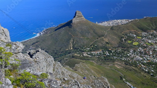 Republic of South Africa. Cape Town (Kaapstad). Panoramic ocean view of the city, Lion's Head, Signal Hill and Robben Island in the background. Table Mountain Cableway with riding cable car to the top