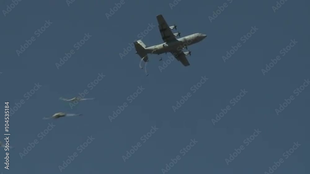 Ground angle view of paratroopers parachuting to earth from a C-17. Ground angle view of paratroopers parachuting to earth from a C-17.