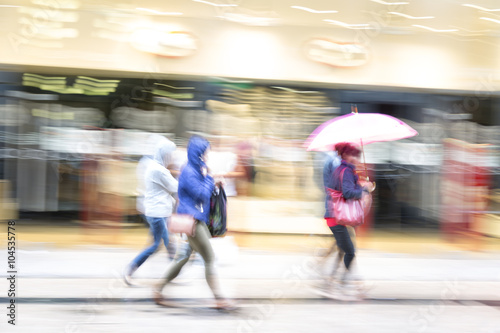 A shopper walking past a store window  shopping spree