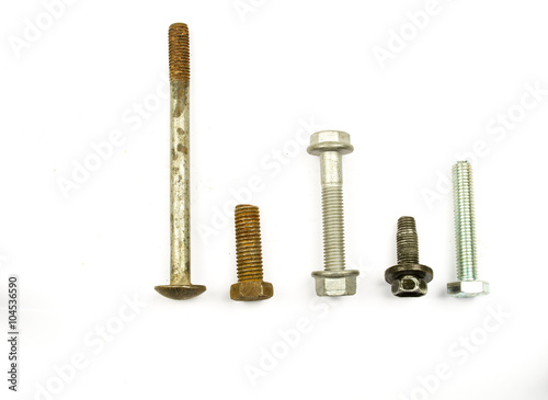 Close-up of various steel nuts and bolts. hardware - bolts  nuts  washers  screws. Nuts and bolts closeup on plain background. Closeup metal screw  bolt and nuts on white background.