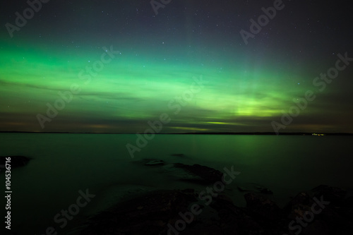 Northern lights over lake in finland © Juhku