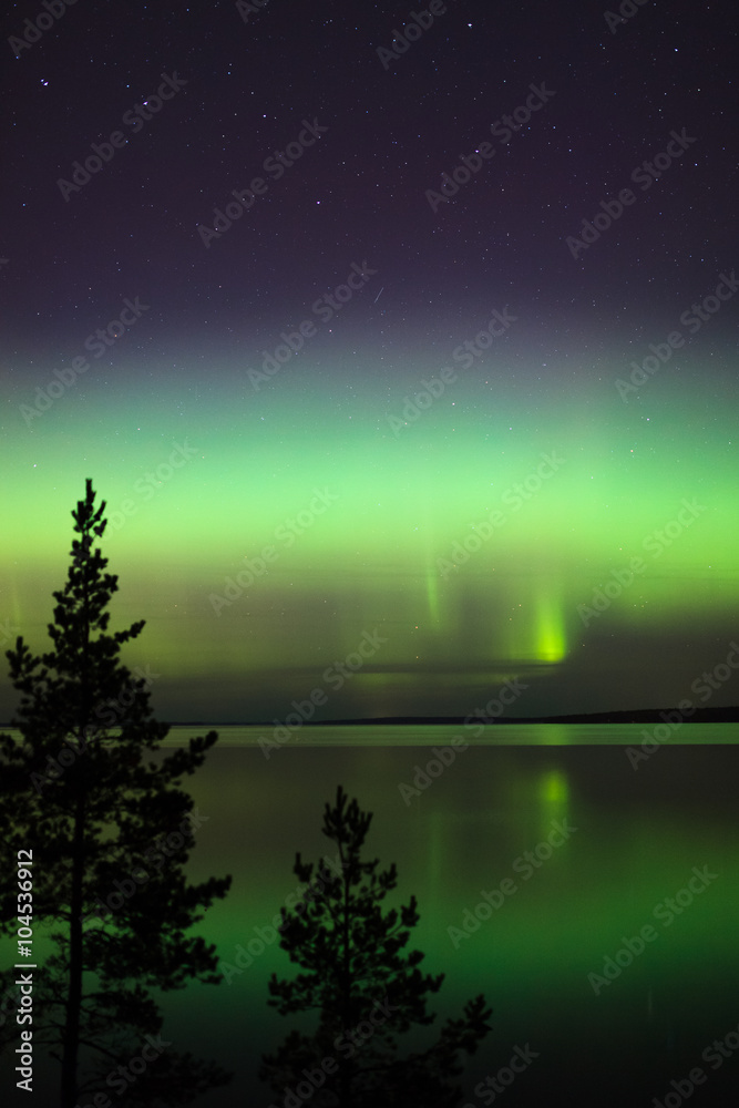Naklejka premium Northern lights over lake in finland