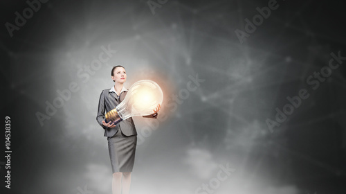 Woman with big bulb in hands