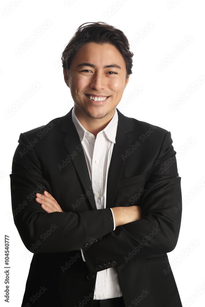An attractive businessman wearing a black suit with a white shirt, standing against a white background with his arms crossed. An attractive businessman wearing a black suit with a white shirt, standing against a white background with his arms crossed.